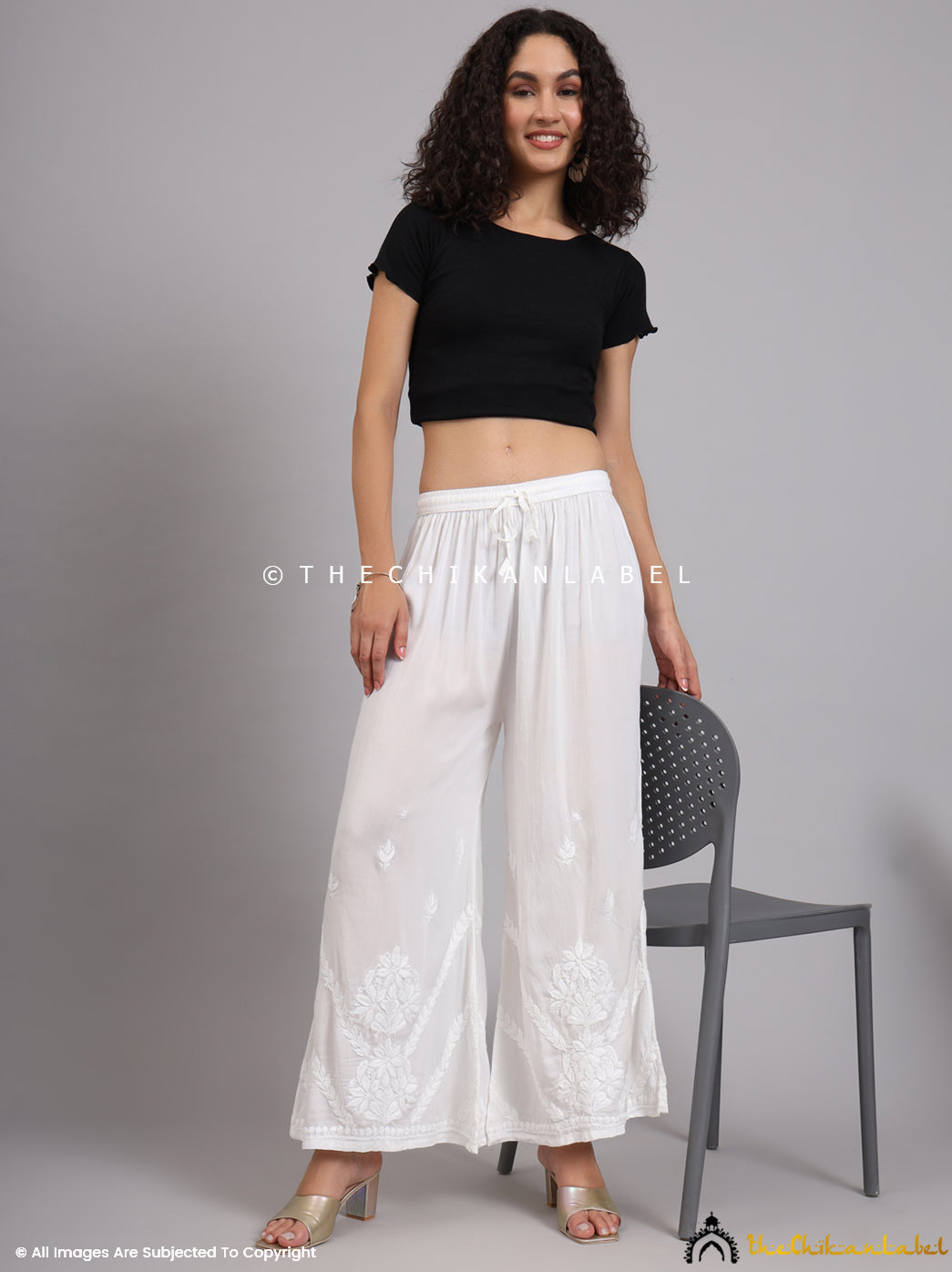 Detailed embroidery near the ankle on white Chikankari palazzo