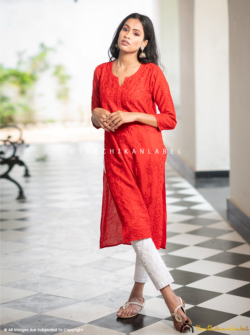 Woman wearing a red chanderi straight kurti with tonal hand-embroidered chikankari.