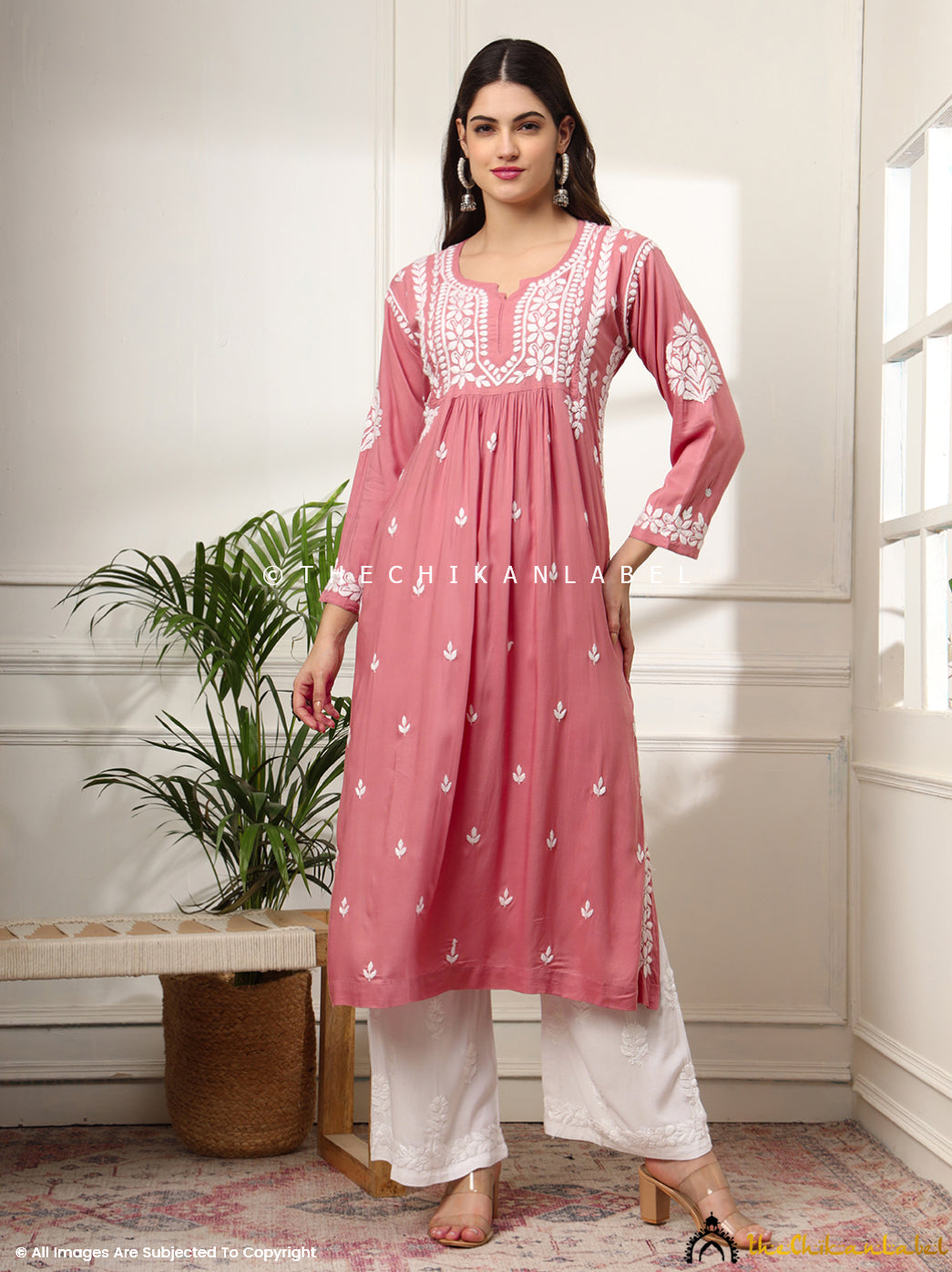 Woman wearing coral rayon chikankari A-line kurti