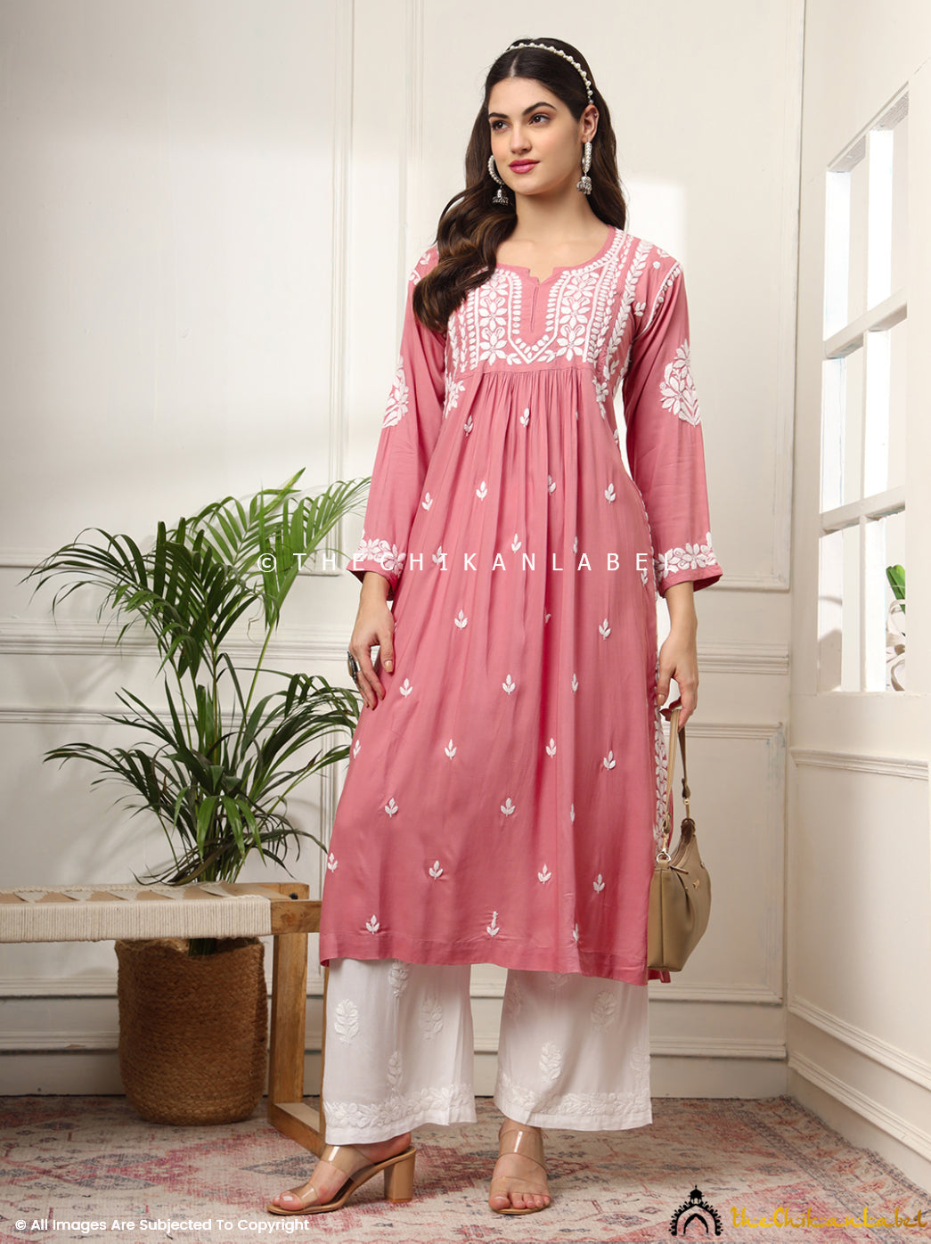 Front view of coral A-line kurti with traditional embroidery