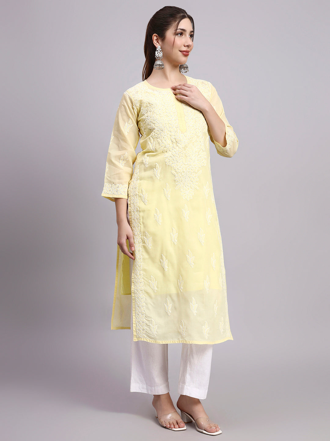 Woman wearing Chikankari cotton kurti with straight silhouette and intricate hand embroidery suitable for comfortable regular wear