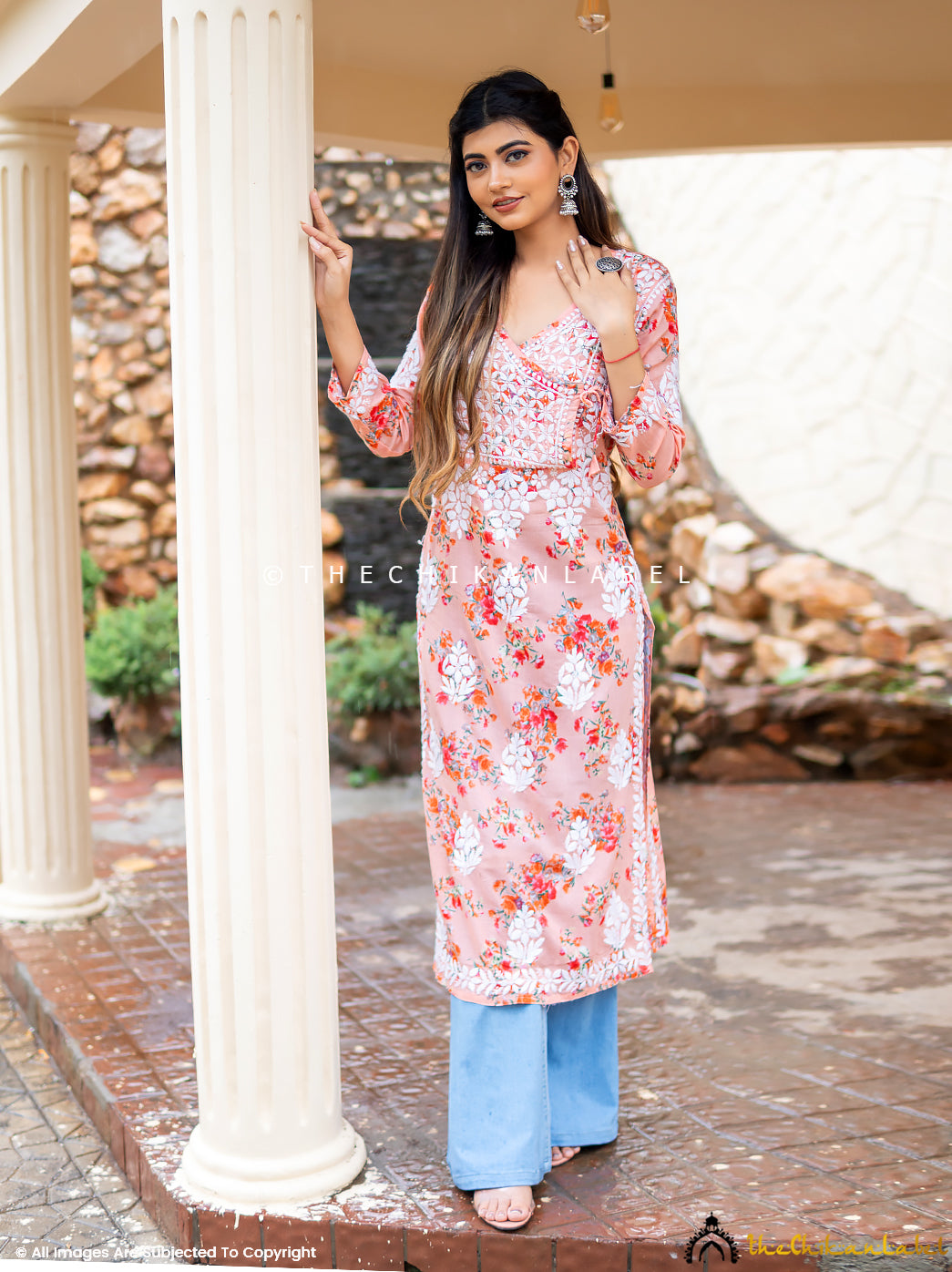 Woman wearing peach floral printed chikankari kurti with V-neckline