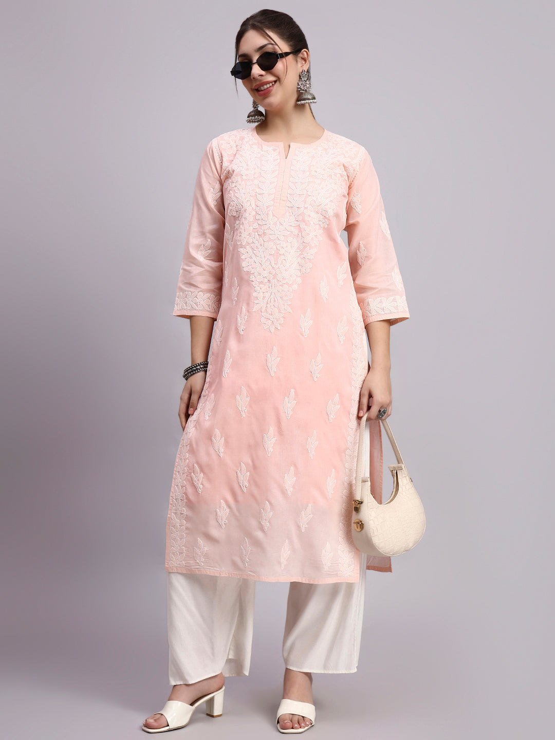 Trending women kurta featuring cotton fabric and detailed Chikankari work styled with minimal accessories for everyday fashion