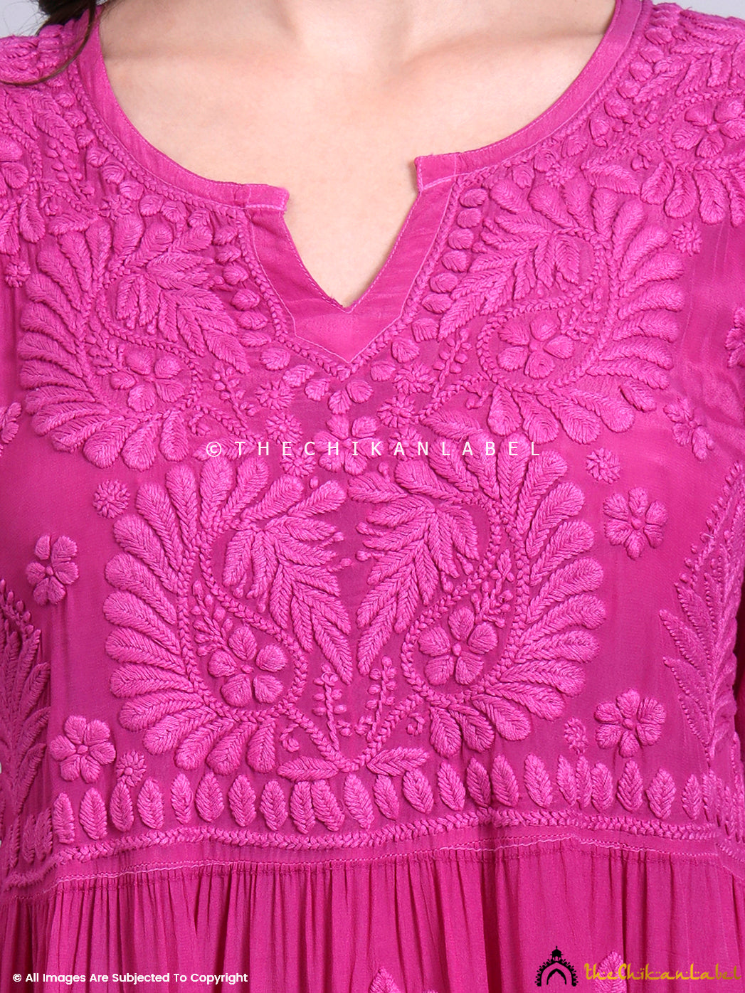 Front view of embroidered chikankari tunic gown with tiered gathers and v-neckline styling.