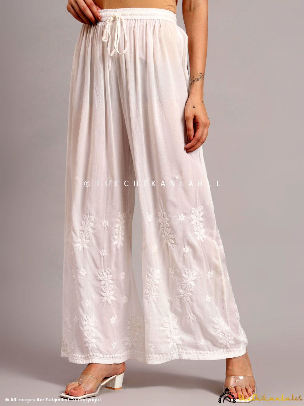 Comfortable regular wear bottom crafted from soft modal fabric with straight fit silhouette and chikankari detailing on the lower leg