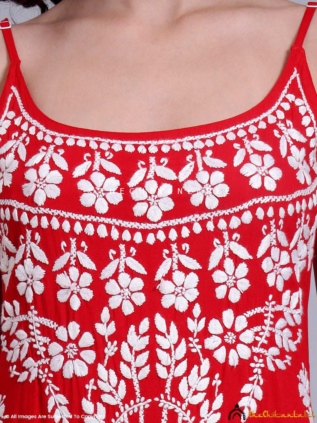 Full-length image of model in handcrafted chikankari long kurta featuring intricate floral embroidery and thin shoulder straps, styled for festive wear.