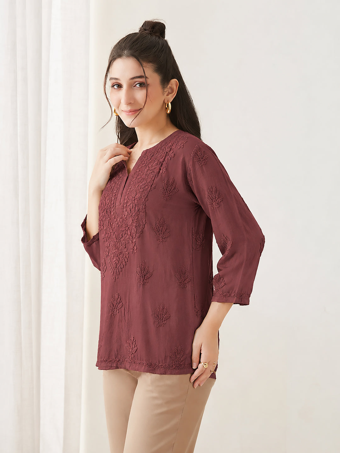 Amina Rayon Short Kurti styled with wide-leg pants, showcasing detailed hand-inspired Chikankari embroidery, a modern short silhouette and comfortable three-quarter sleeves.