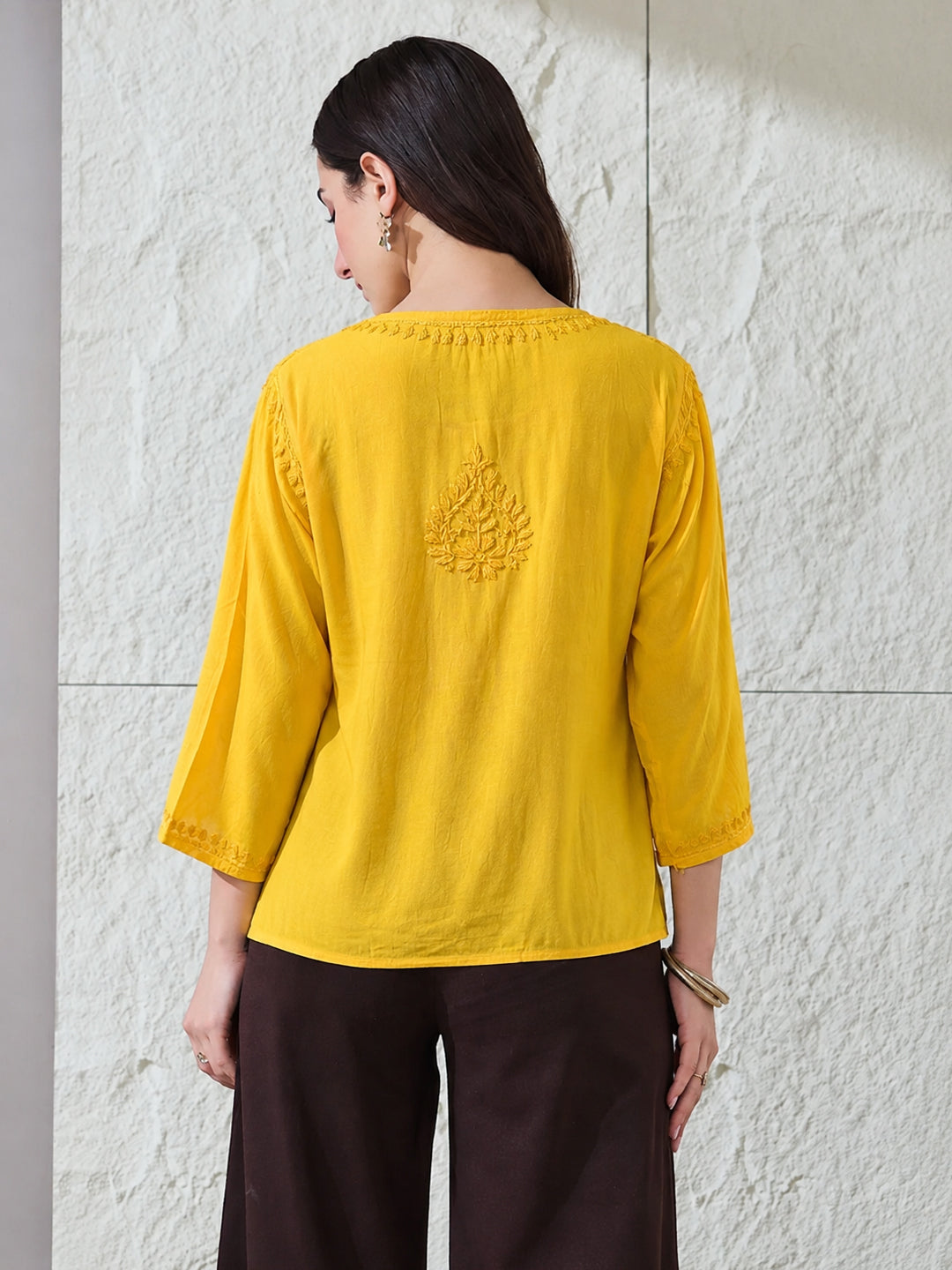Elegant Chikankari short kurti for women crafted in comfortable rayon fabric with floral embroidered motifs, relaxed fit and modern styling for everyday occasions.
