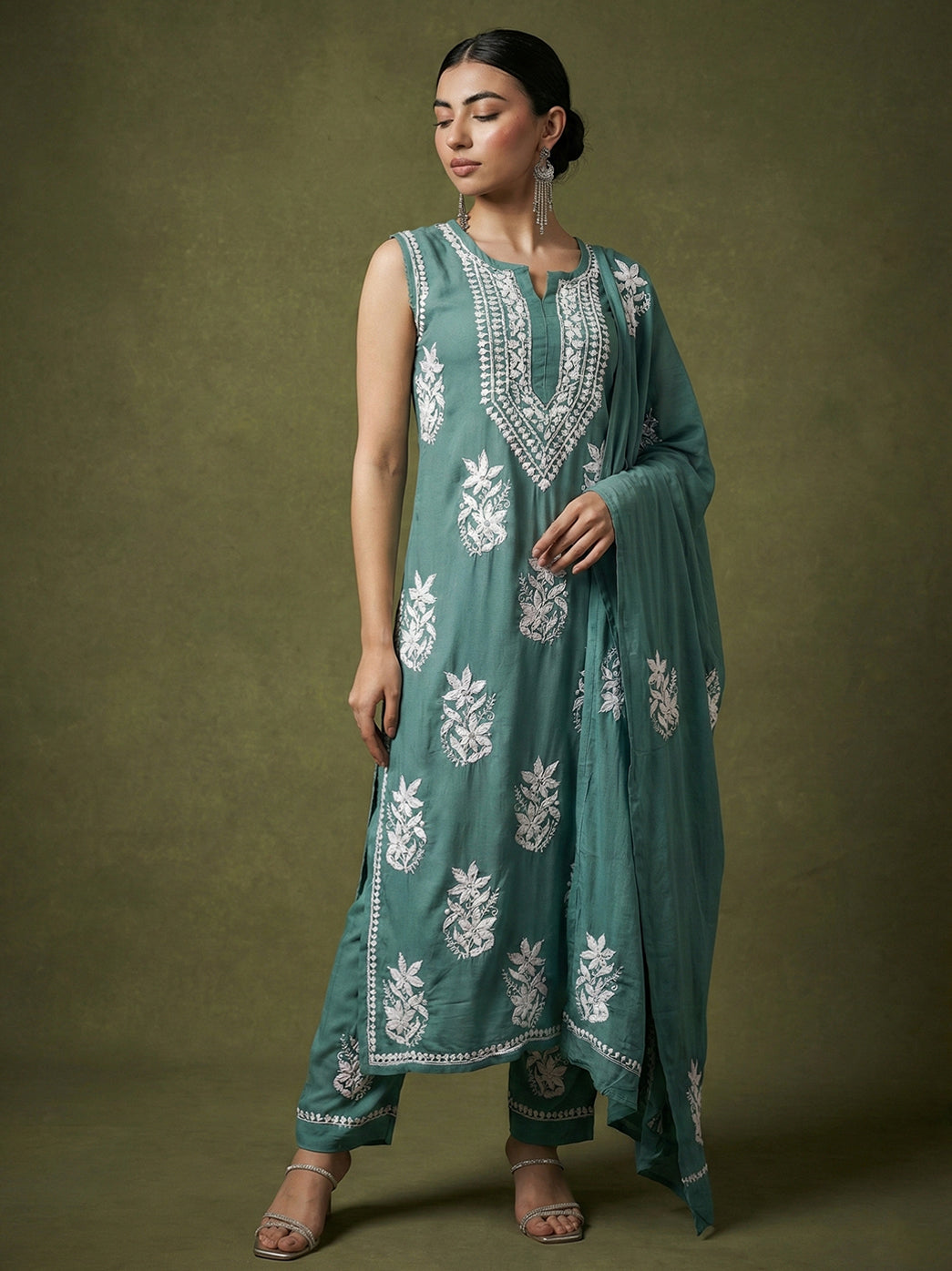 Handcrafted chikankari kurta with detailed neckline embroidery and all-over floral handwork, styled with matching pants and flowing dupatta for ethnic wear