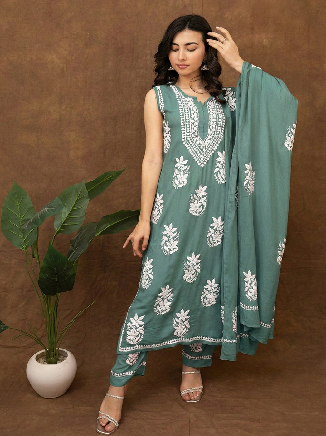 Traditional Lucknowi chikankari kurta set highlighting fine hand embroidery on soft fabric, worn with straight fit bottoms and embroidered dupatta