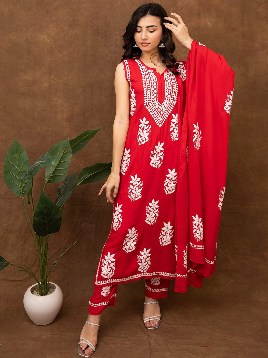Sleeveless chikankari kurta set with hand embroidered floral motifs, paired with straight pants and matching dupatta, featuring traditional Lucknow craftsmanship