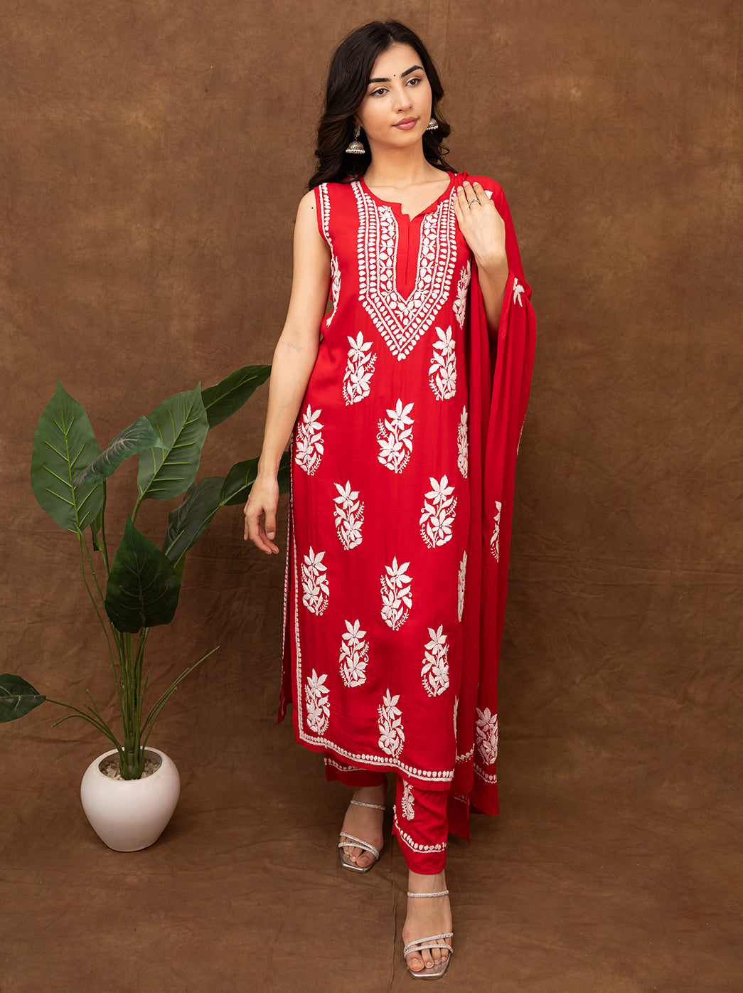 Traditional chikankari embroidered kurta set with detailed neckline embroidery, straight fit pants, and lightweight dupatta, styled for ethnic celebrations
