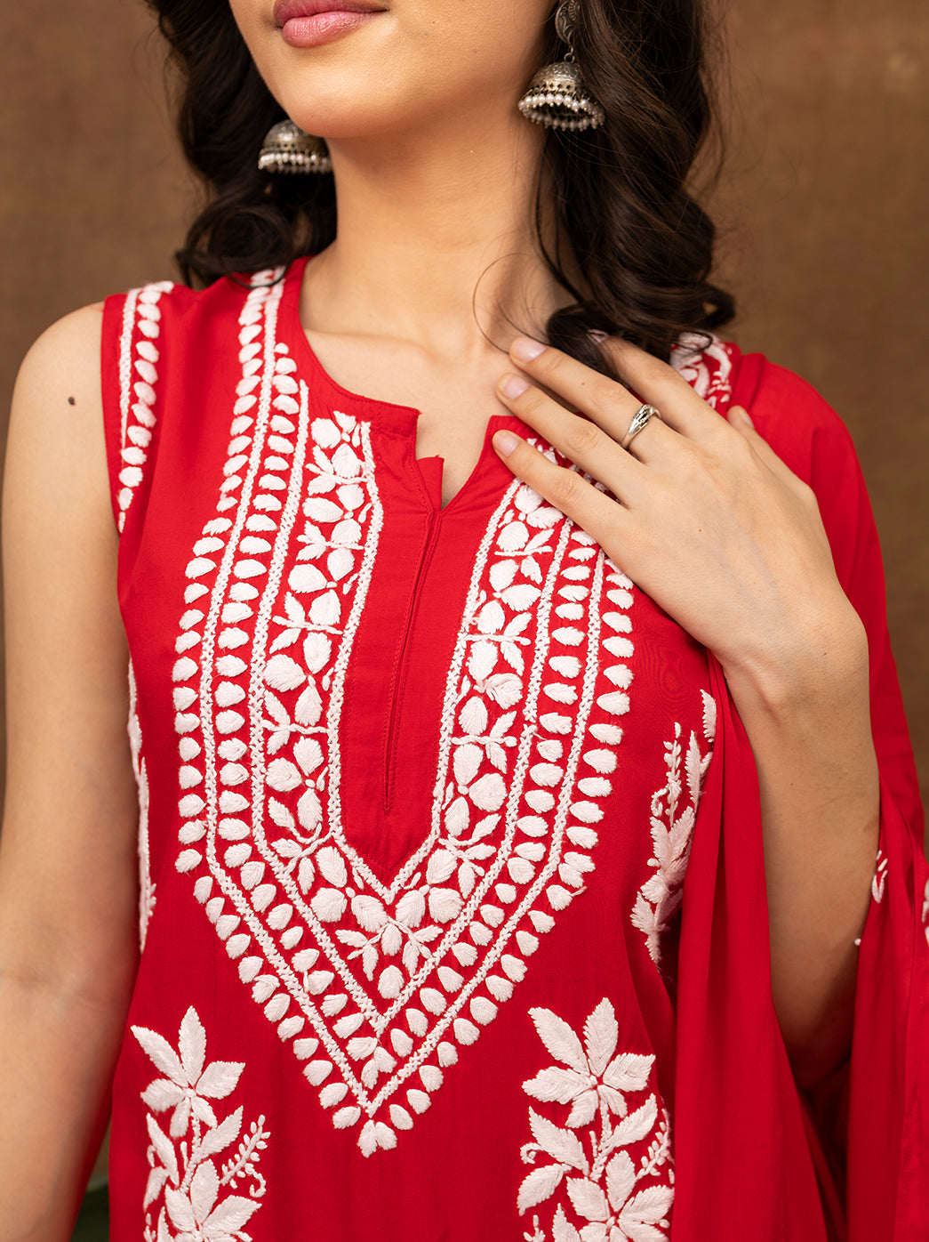 Handcrafted chikankari kurta set showcasing intricate floral embroidery on soft fabric, styled with embroidered pants and a flowy dupatta for ethnic wear