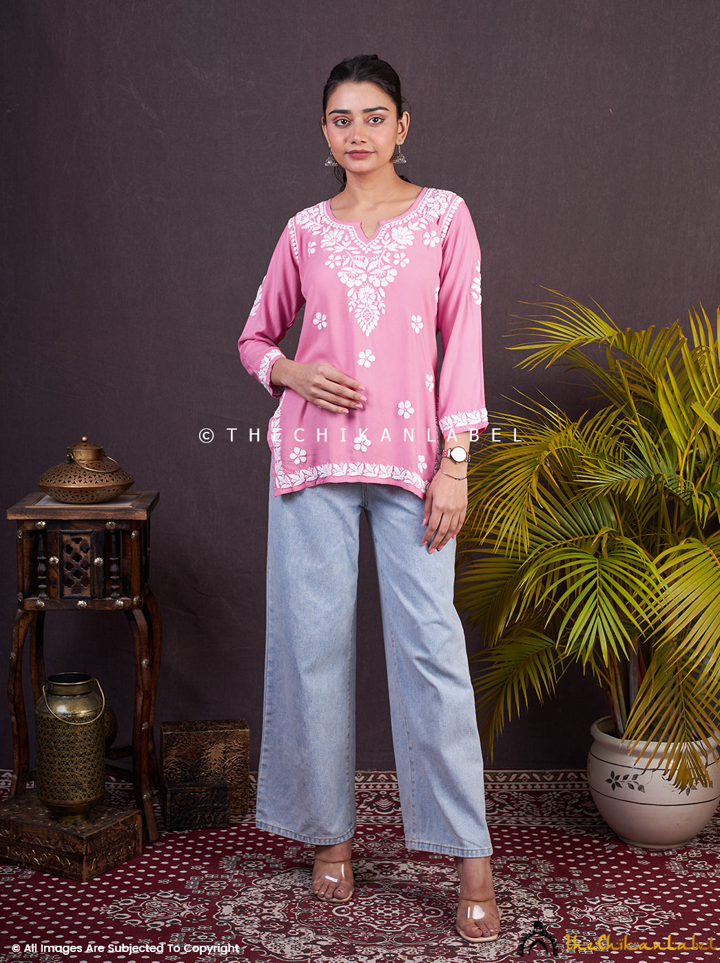 Model wearing Sangeet baby pink chikankari short kurta with jeans