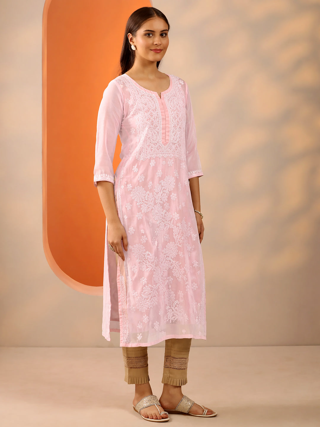 Women wearing cotton straight kurti with intricate chikankari embroidery in a comfortable regular wear ethnic outfit