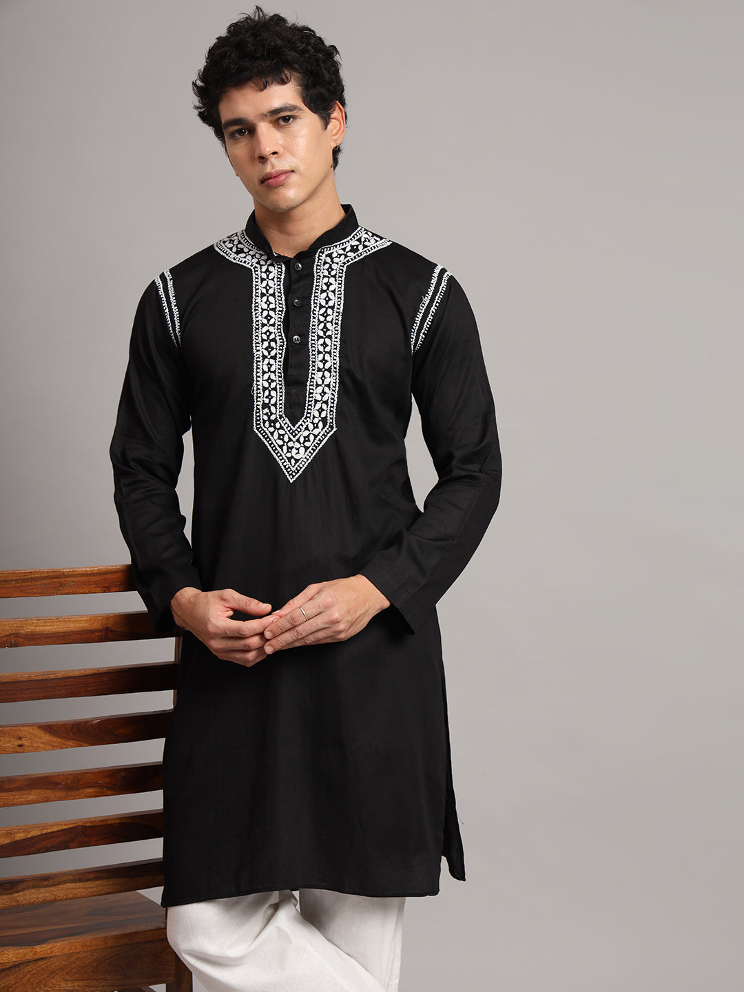Men's ethnic outfit featuring the Uman Chikankari kurta, with a structured mandarin neckline, long sleeves and a straight silhouette paired with trousers and open-toe sandals.