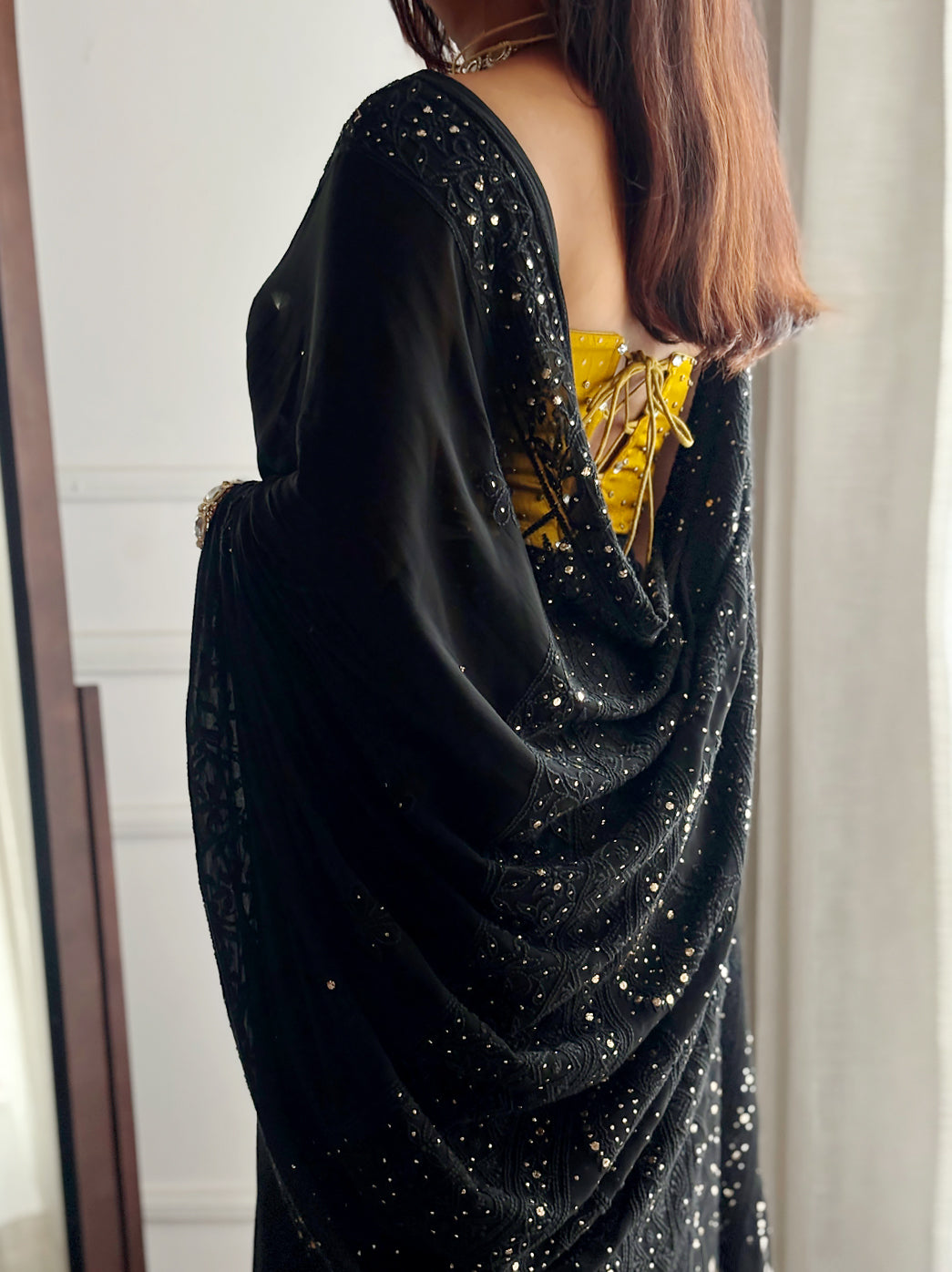 Full-length viscose mukaish chikankari saree with dazzling metallic highlights, styled with bold accessories for a glamorous look