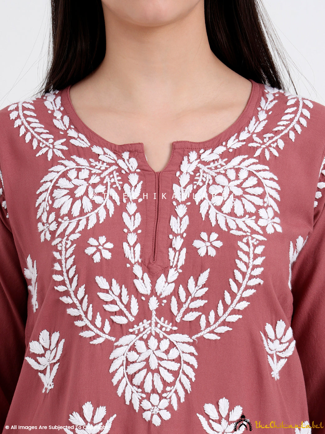 Handcrafted rayon short top with intricate Lucknowi work, styled with light jewelry for an elegant daytime ethnic outfit.