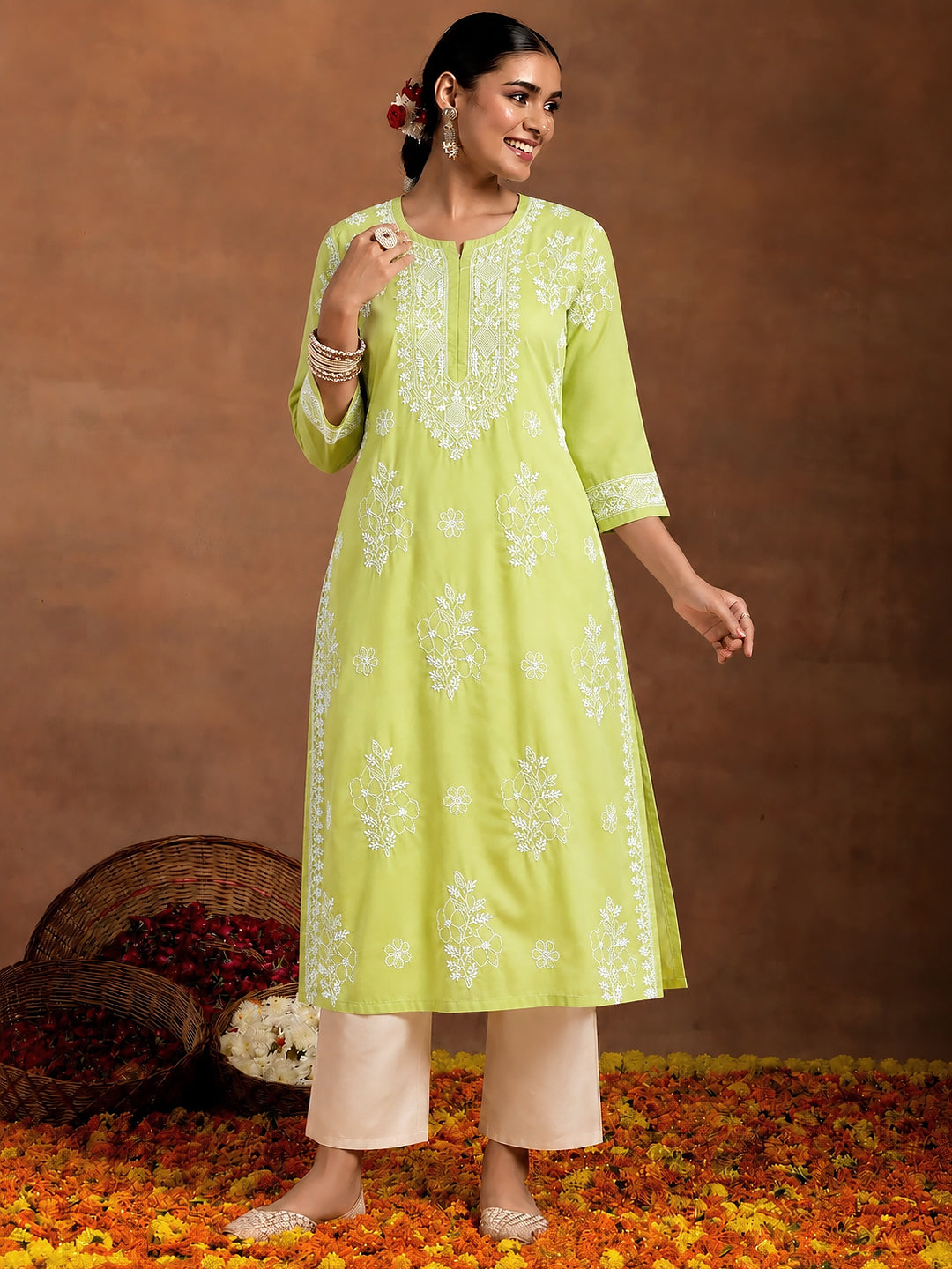 Comfortable regular wear kurta with intricate Chikankari floral embroidery, breathable cotton fabric, three-quarter sleeves and straight silhouette for women.