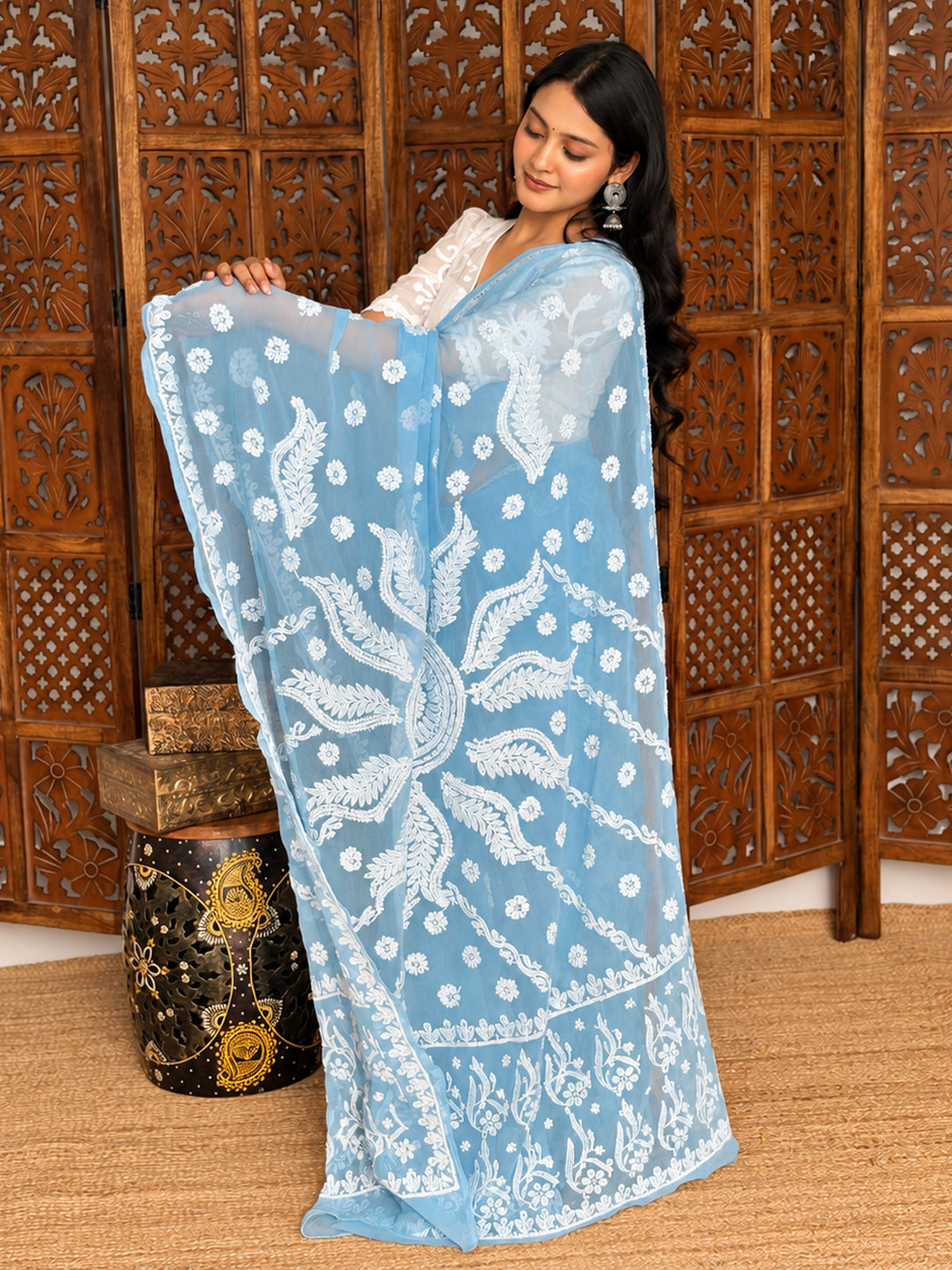 Dityaa Georgette Chikankari Saree showcasing delicate embroidered floral patterns, ornate traditional motifs, and a statement pallu with detailed threadwork for an elegant and graceful ethnic appearance.