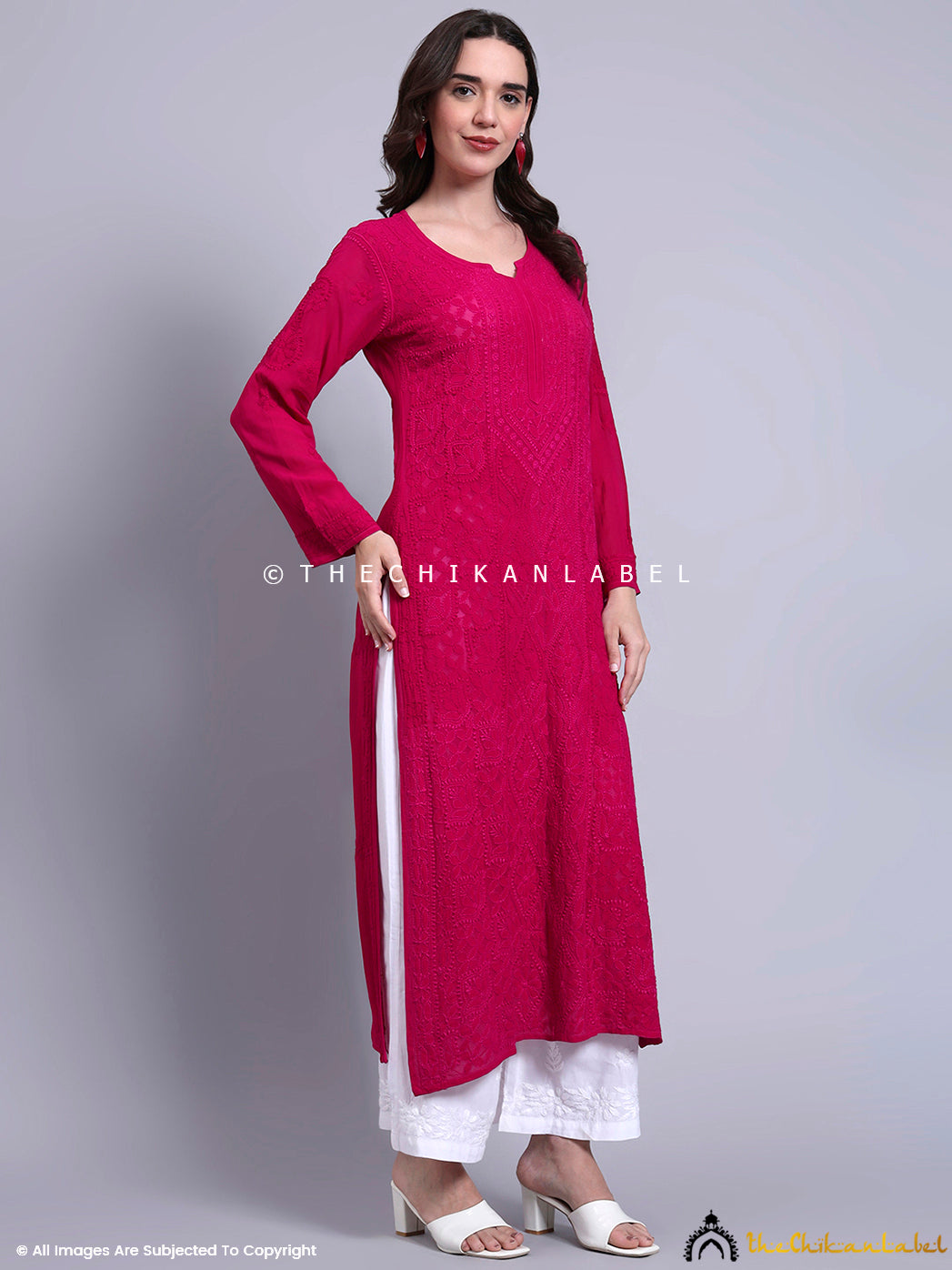 Front view of straight viscose kurti with hand-embroidered motifs, paired with contrasting embroidered palazzos.