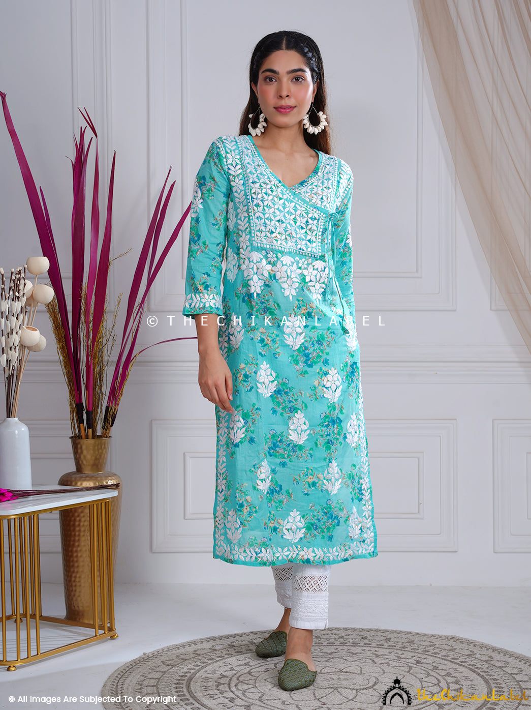 Woman wearing green floral chikankari kurti with V-neck and white embroidery