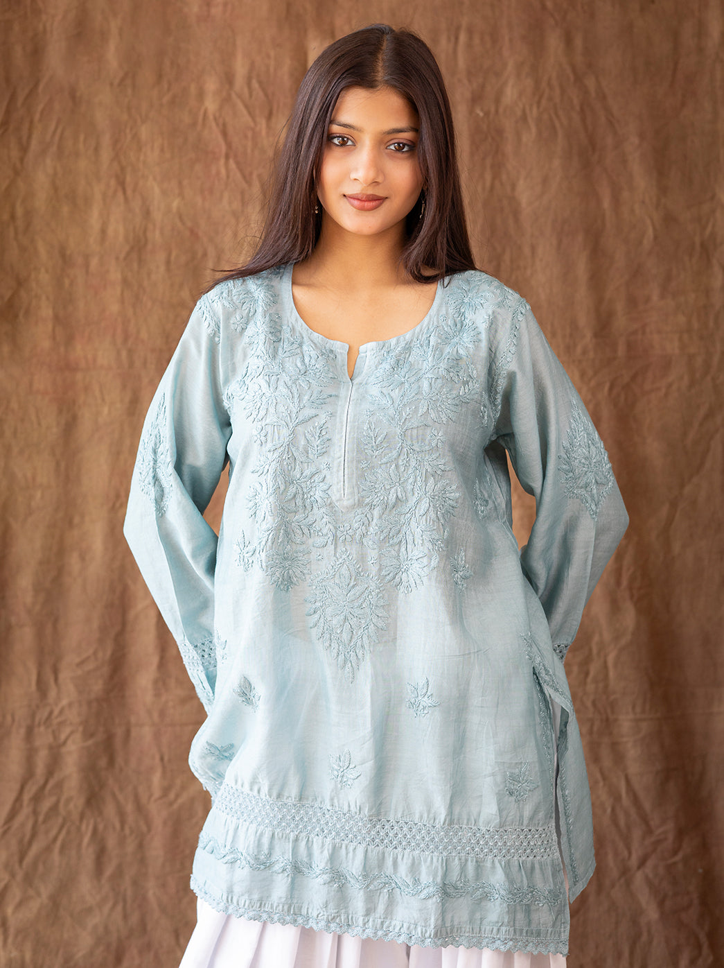 Ethnic chikankari kurti featuring detailed floral embroidery, paired with classic farshi salwar inspired by traditional Awadhi fashion