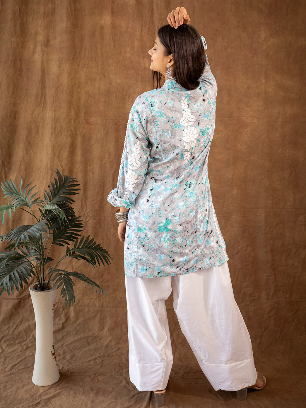 Traditional mulmul chikankari kurta showcasing fine hand embroidery across the front and sleeves, worn with relaxed farshi style bottoms