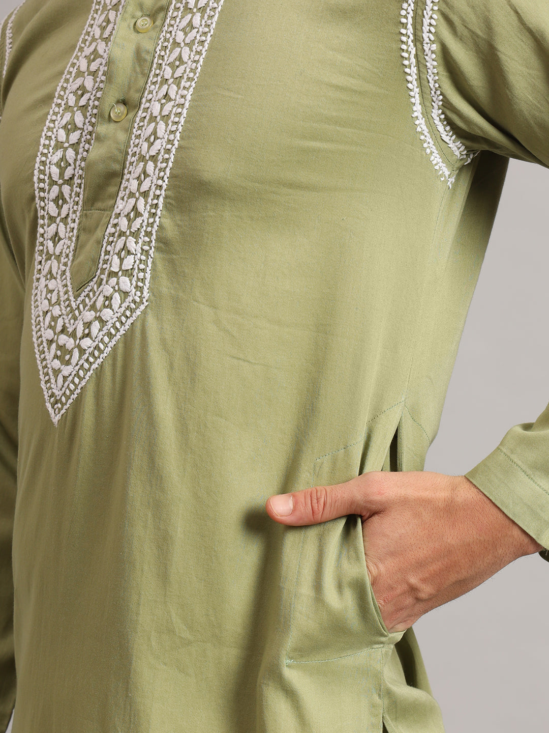 Uman Mens Kurta worn by a standing model, showcasing floral and leafy embroidery framing the front placket and delicate embroidered lines along the shoulders.