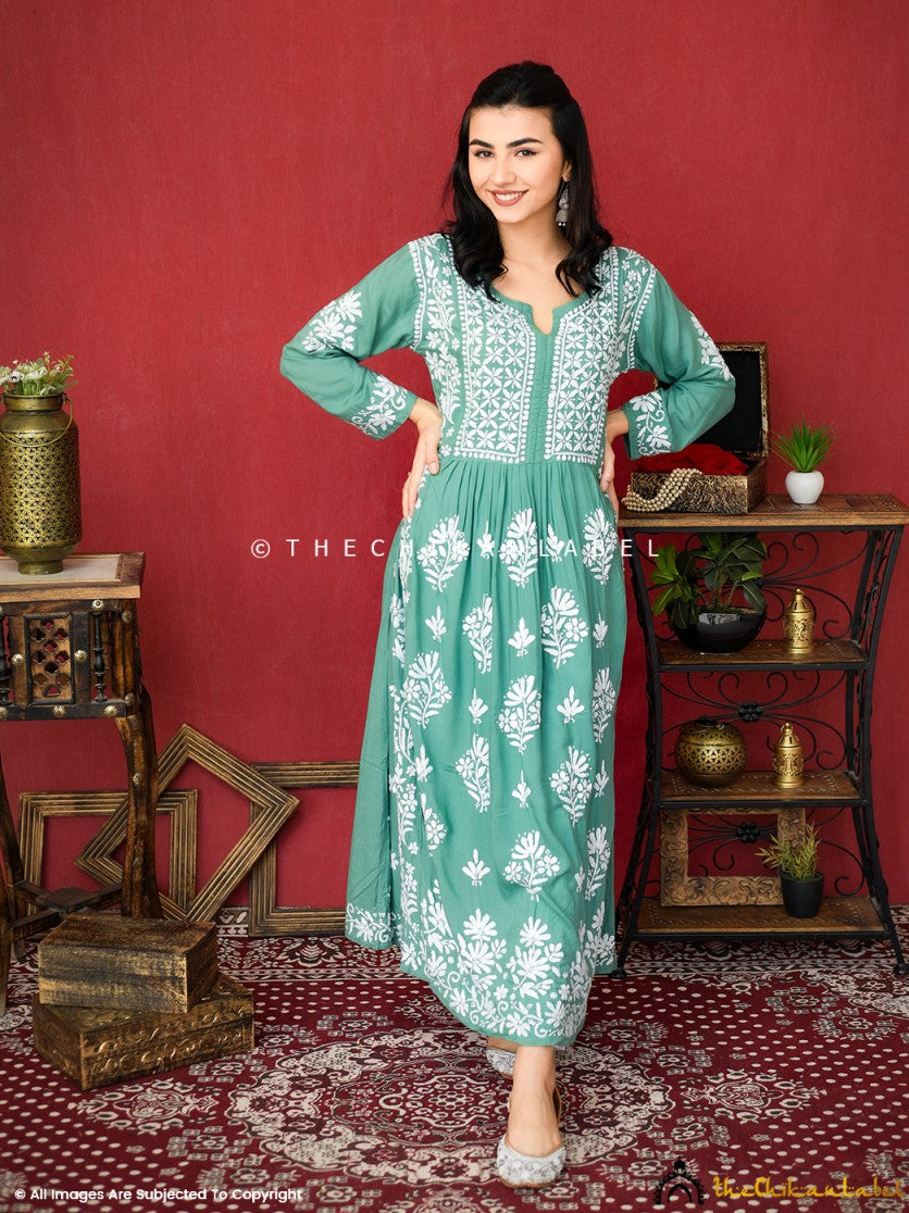Woman wearing green A-line chikankari kurti with white embroidery