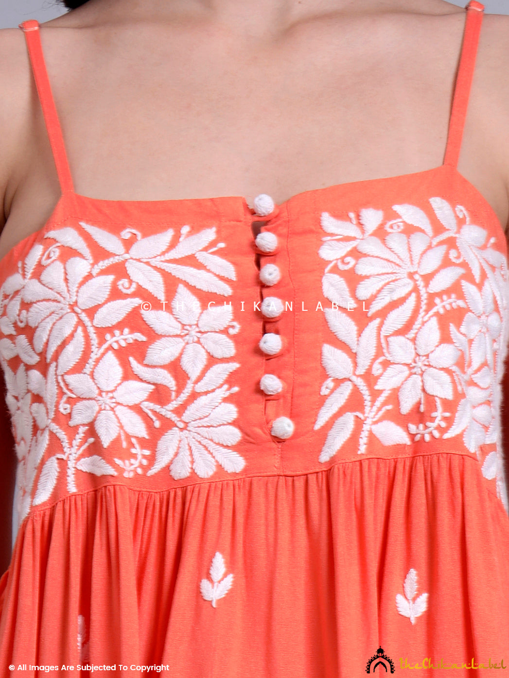 Festive casual kurta featuring thin shoulder straps, soft modal texture, and handcrafted embroidery, styled for day events and summer outings.