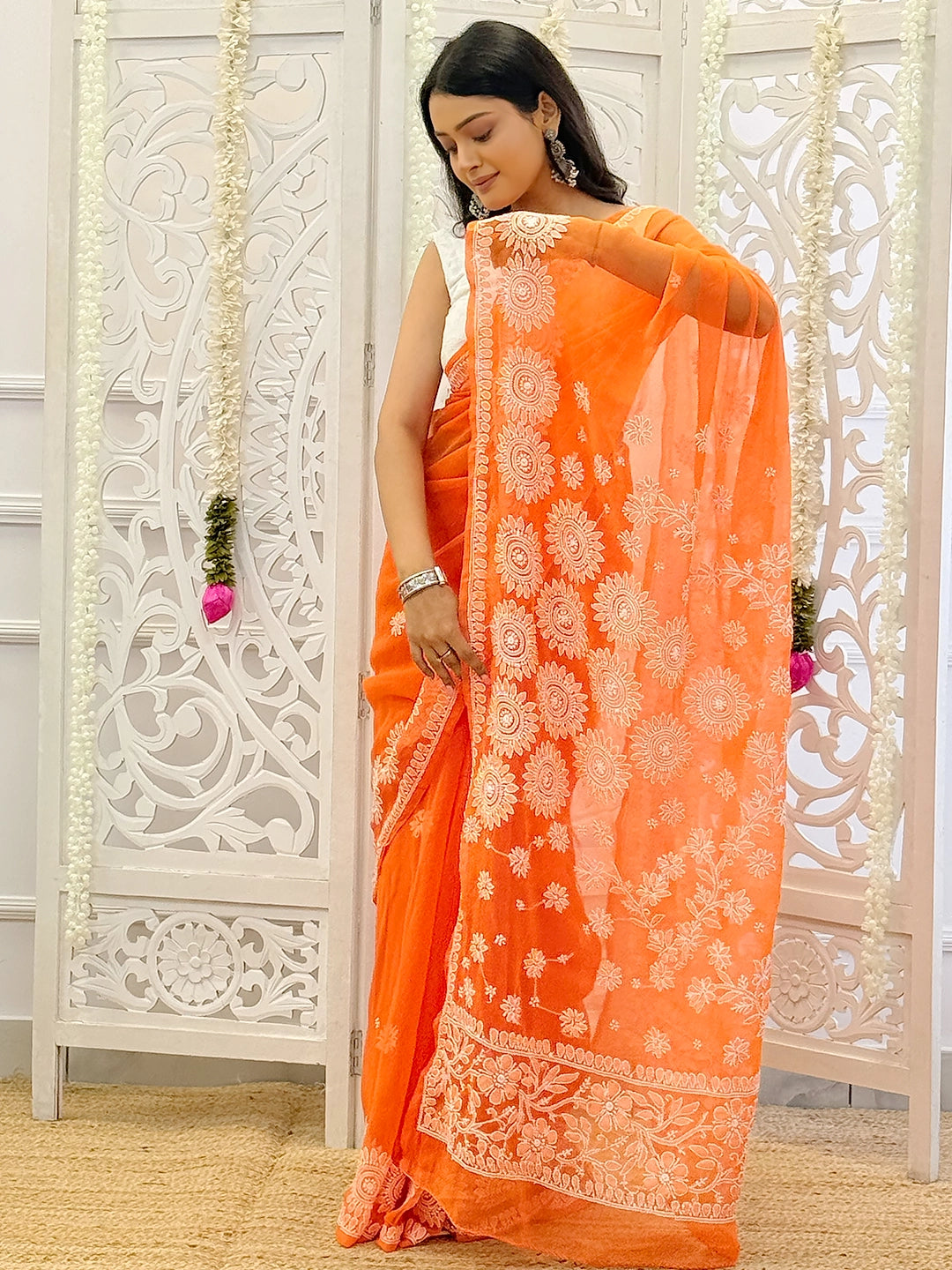 Premium georgette saree with hand-embroidered floral chikankari patterns ideal for weddings and celebrations.
