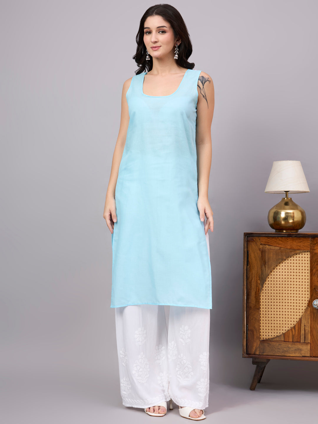 Women's trending kurti featuring handcrafted Lucknow Chikankari embroidery, premium cotton construction, soft inner lining, and elegant straight-fit styling.