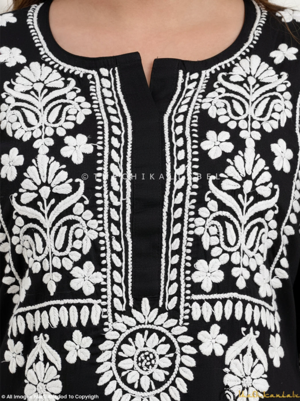 Traditional cotton chikankari suit set featuring floral hand-embroidered motifs on kurta and trousers for festive and office wear