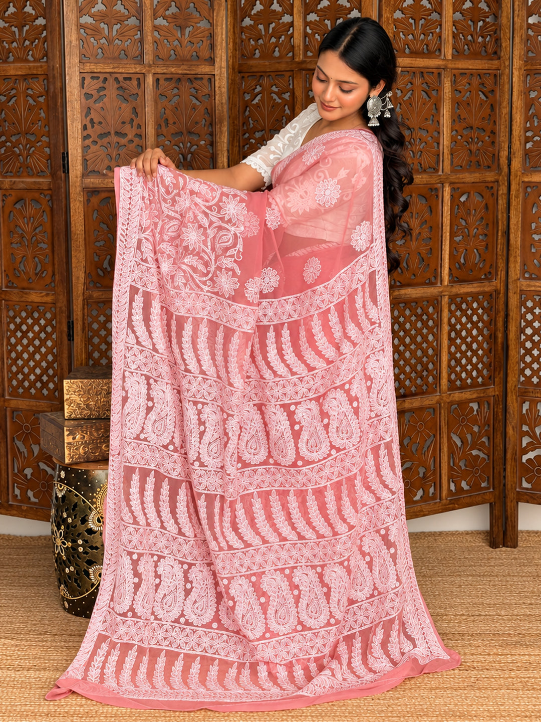 Kiana Georgette Chikankari Saree featuring floral vine embroidery near the lower drape and an ornate pallu with repeating paisley motifs.