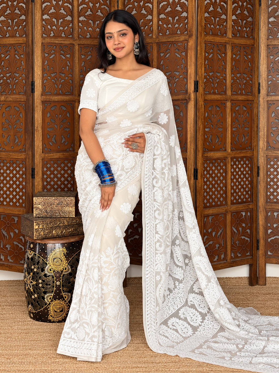 Model wearing the Kiana Georgette Chikankari Saree with scattered floral embroidery, decorative borders and an elaborate pallu draped over her shoulder.