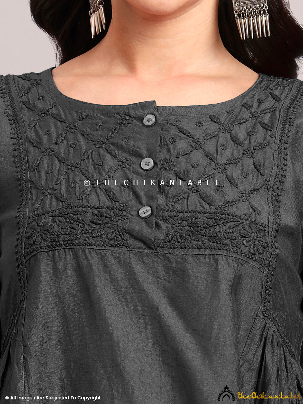 Lightweight Chanderi short kurta featuring fine Chikankari work on the yoke, styled with white palazzos for a summer ethnic look