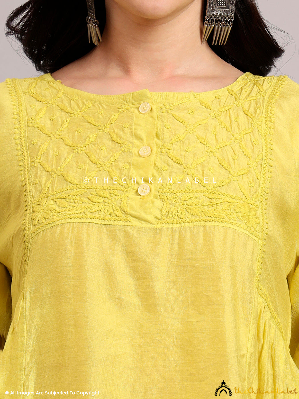 Lightweight Chanderi short kurta featuring fine Chikankari work on the yoke, styled with white palazzos for a summer ethnic look