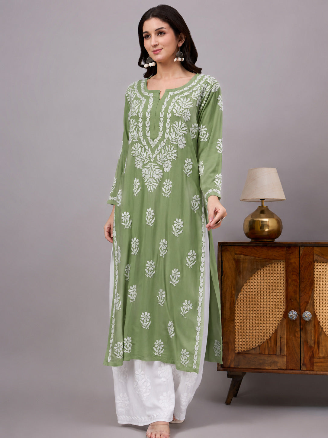 Comfortable regular wear kurti with handcrafted Chikankari embroidery, breathable rayon fabric, classic straight silhouette, and versatile styling for work, travel, and everyday fashion.