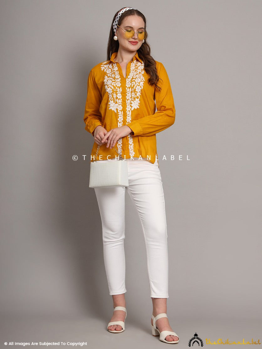 Woman wearing mustard yellow mulmul chikankari shirt with white embroidery