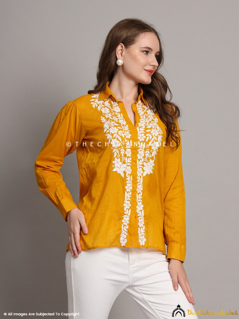 Model styling mustard shirt with traditional palazzos and jhumkas
