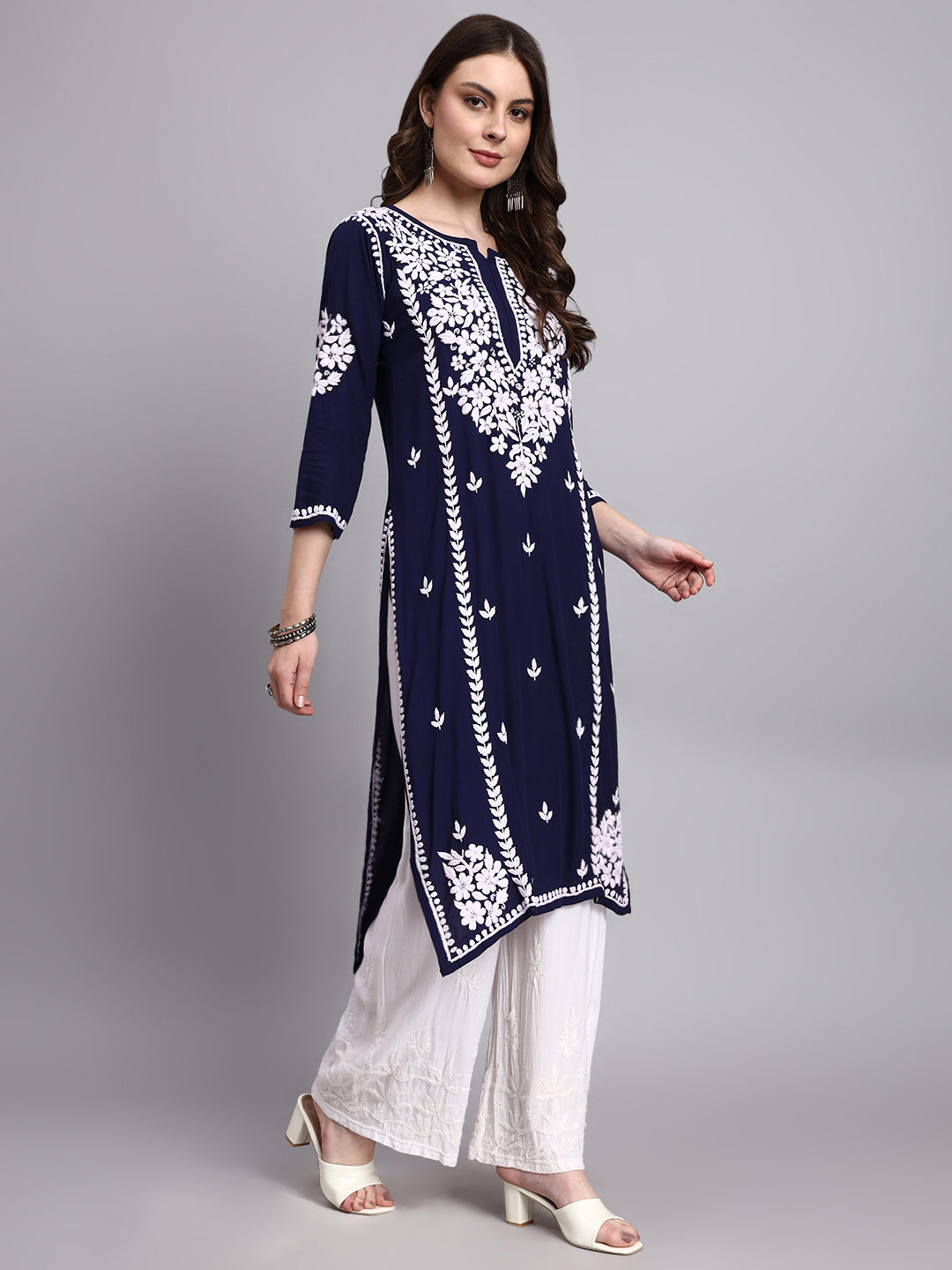 Woman wearing a rayon chikankari long kurta featuring handcrafted floral embroidery with straight fit silhouette and elegant neckline design