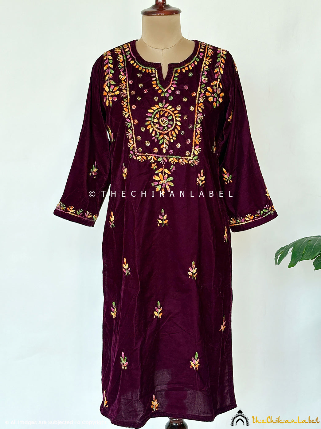 Handcrafted velvet chikankari straight kurta with detailed sleeve embroidery and traditional floral buttis photographed for festive wear.