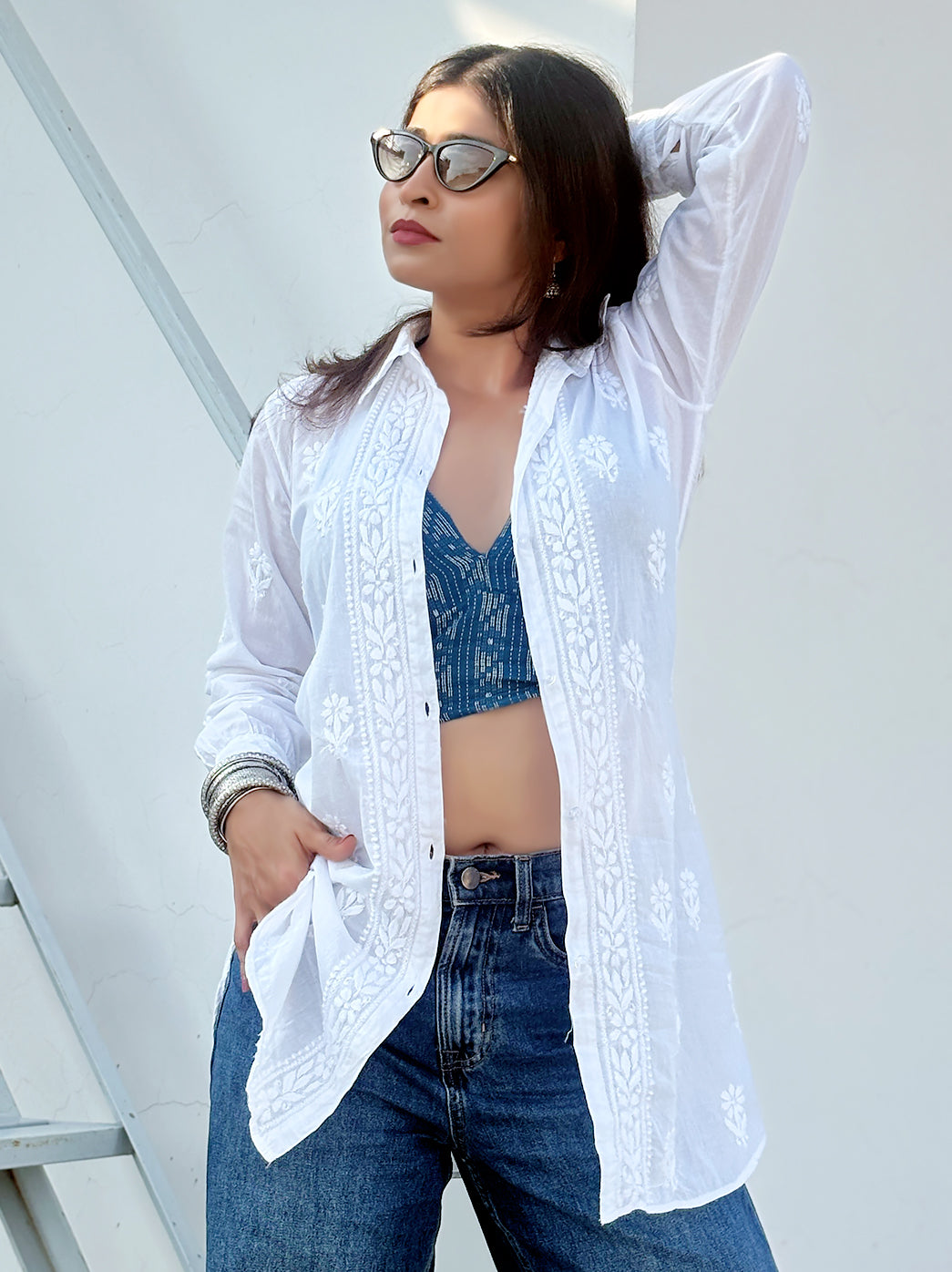 Woman wearing a mulmul chikankari shirt with handcrafted floral embroidery, styled as a breathable summer wear shirt for casual outings