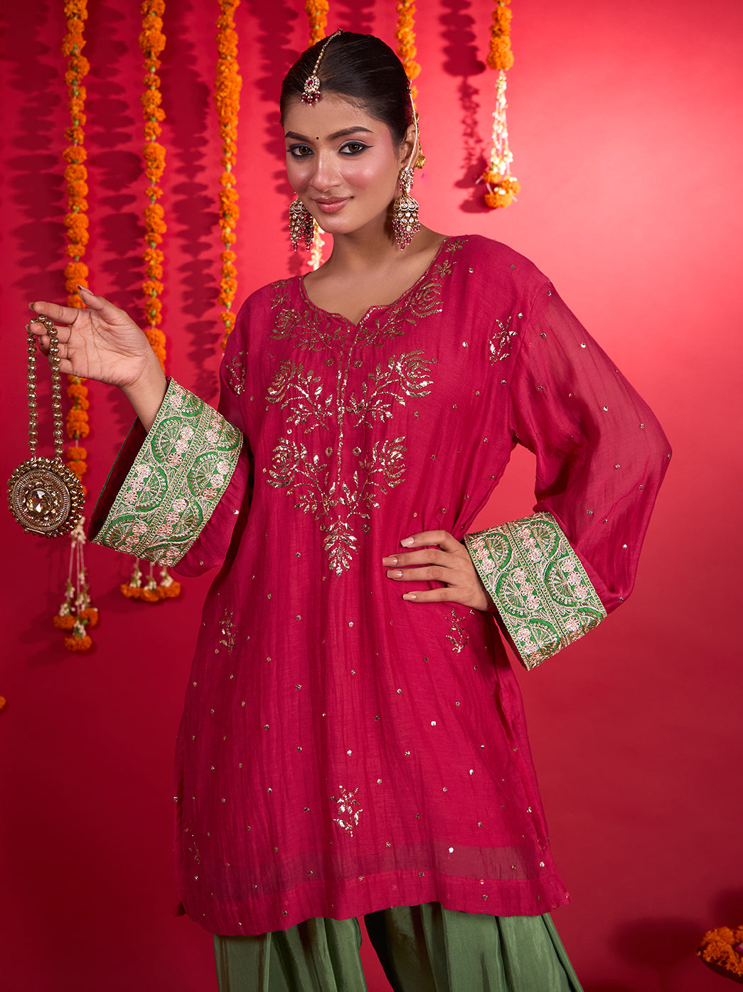 Noorani festive wear set with floral embroidery across the kurti front, scattered shimmering accents and wide Farshi pants finished with ornate borders.