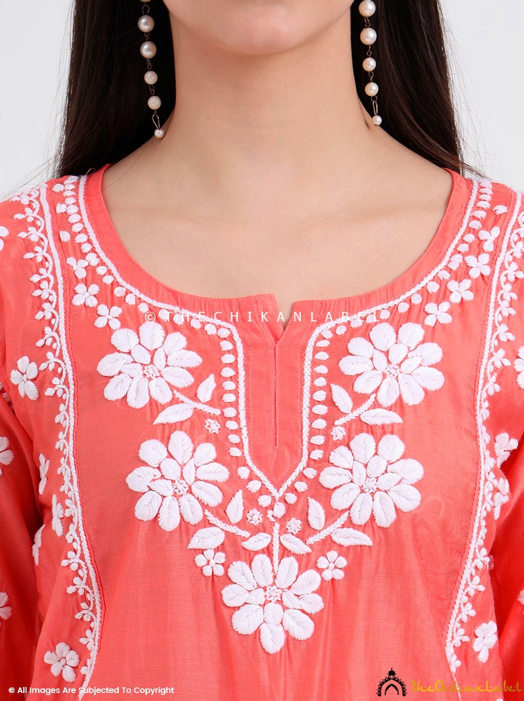 Front view of a chikankari chanderi short kurti with floral embroidery and side slits for easy movement and airflow.