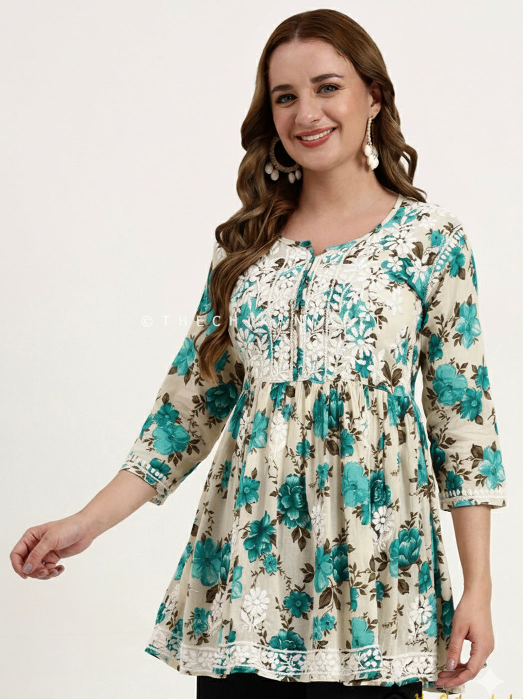 Lightweight mulmul cotton short top with intricate Chikankari work on the yoke and an elegant printed design for women.