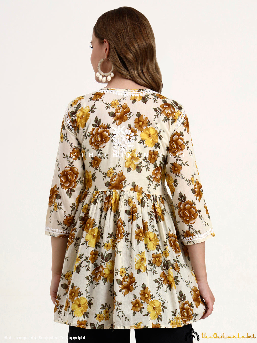 Hand-embroidered Chikankari short top made from breathable mulmul cotton, styled with floral prints and comfort-fit sleeves.