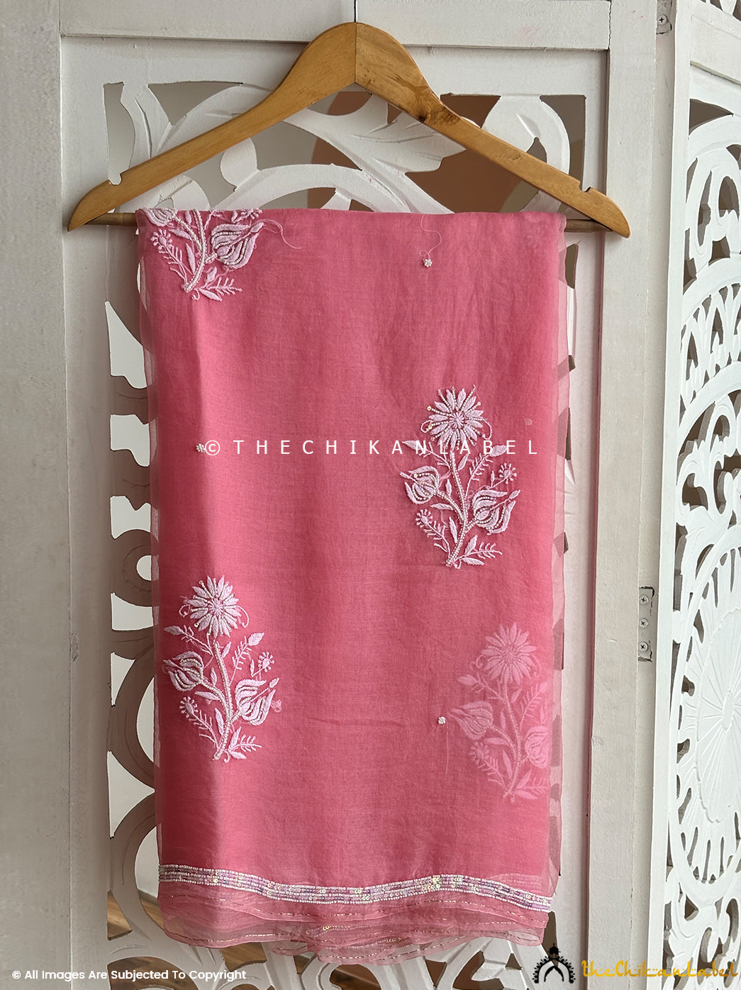 Model wearing an elegant organza chikankari pearl work saree featuring intricate hand embroidery and shimmering pearl details perfect for traditional ceremonies and festive celebrations.