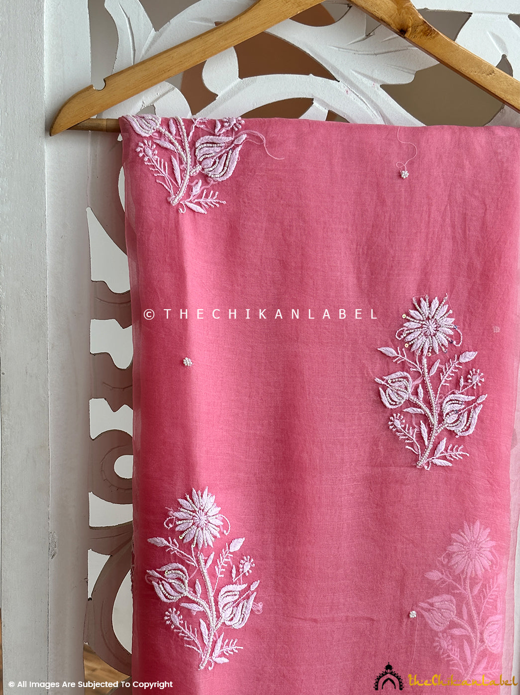 Traditional Lucknowi organza saree with chikankari and pearl embroidery work styled as festive wear, symbolizing timeless Indian artistry.